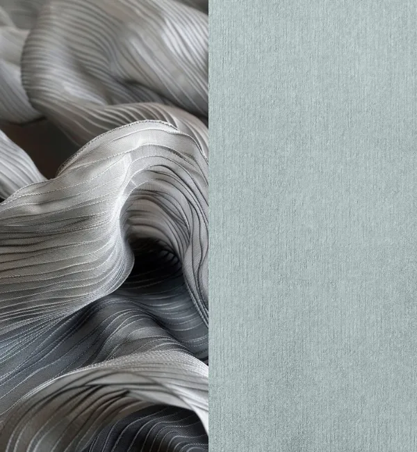 Pleated grey fabric drapes next to a textured pale blue surface.