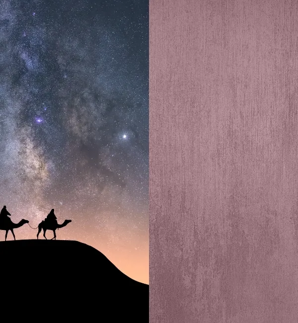 Silhouettes of camels and riders traverse a desert dune under a starry night sky.
