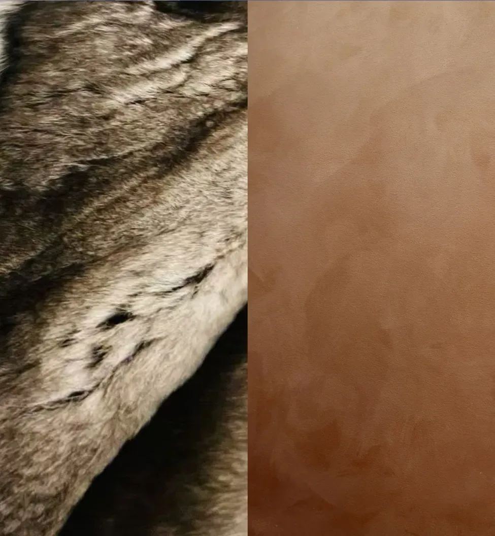 Close-up of a grey and black striped fur texture next to a smooth, tan leather surface.