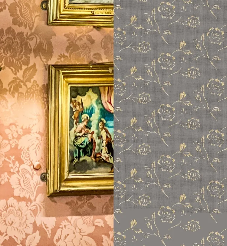 A framed religious painting hangs on a wall with ornate floral wallpaper.